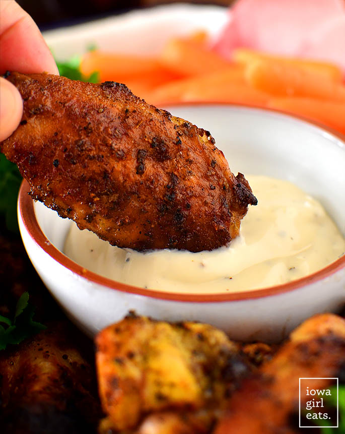 crispy smoked chicken wing dipped into sauce