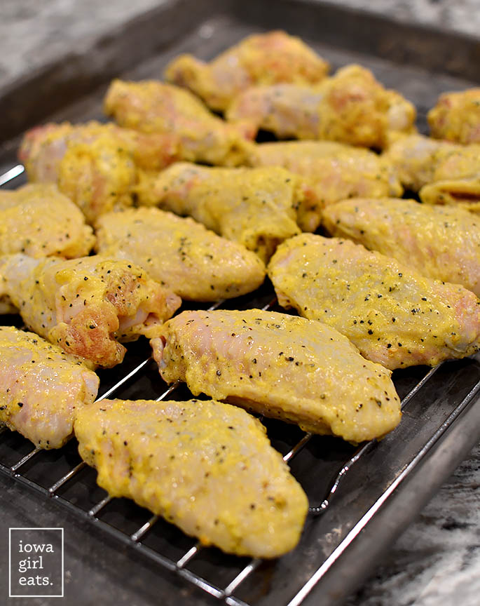 lemon pepper seasoned chicken wings on a baking sheet