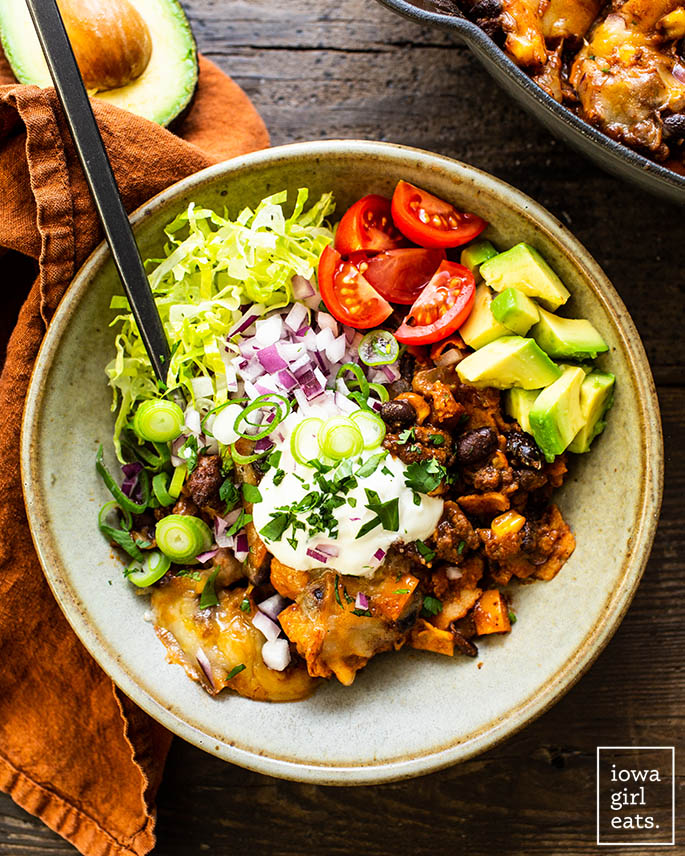 Bowl of skillet beef enchiladas with toppings