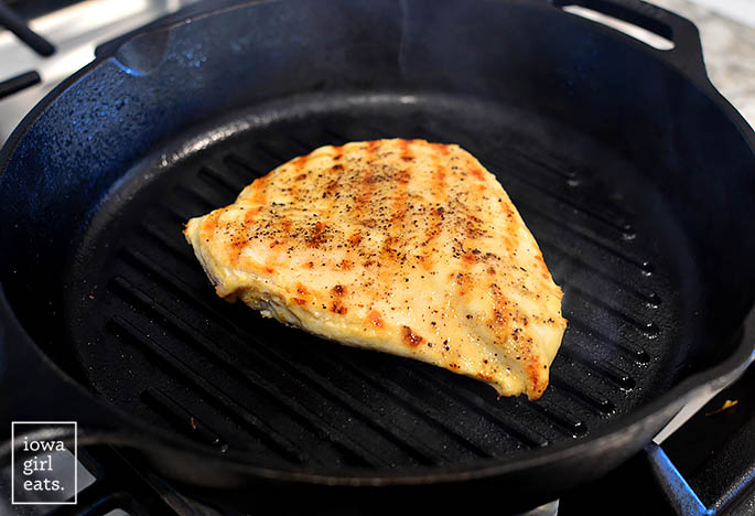 chicken breast being cooked in a grill pan
