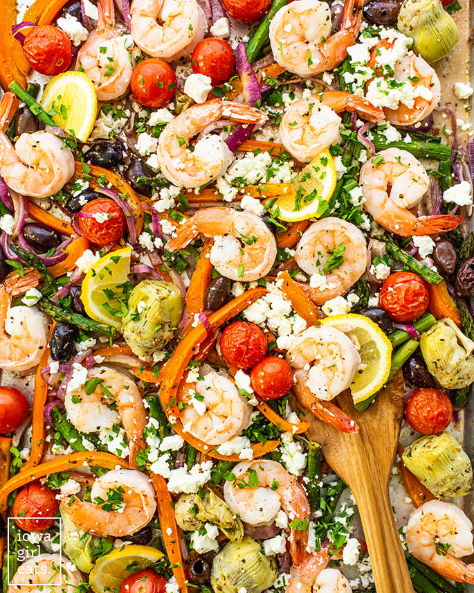 close up photo of mediterranean shrimp and vegetables on a sheet pan