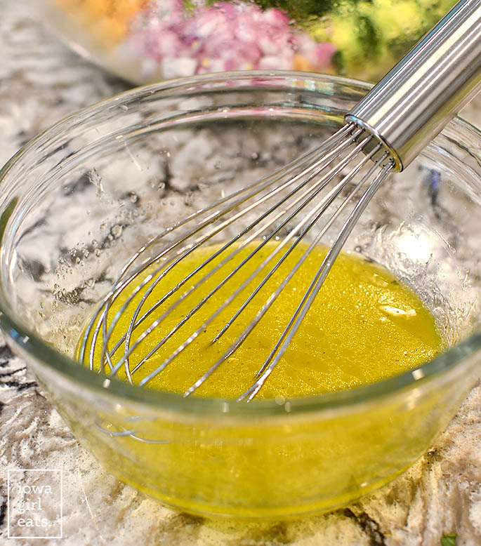 lemon dressing in a bowl with a whisk