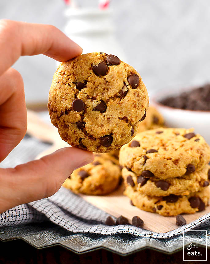 Hand holding an almond flour chocolate chip cookie