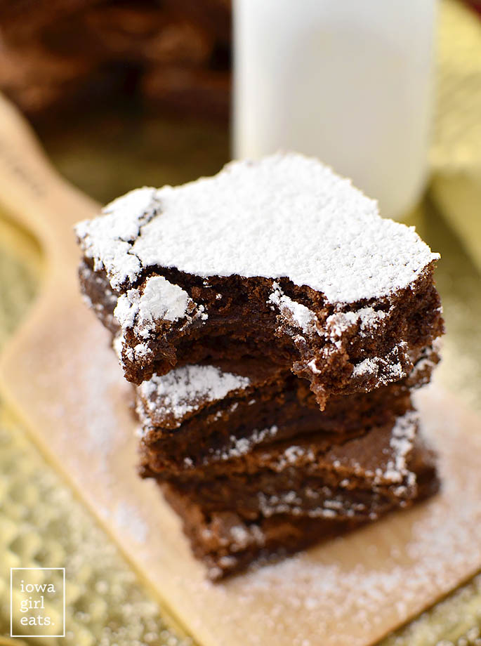 Stack of 4 gluten-free brownies with bite taken from top