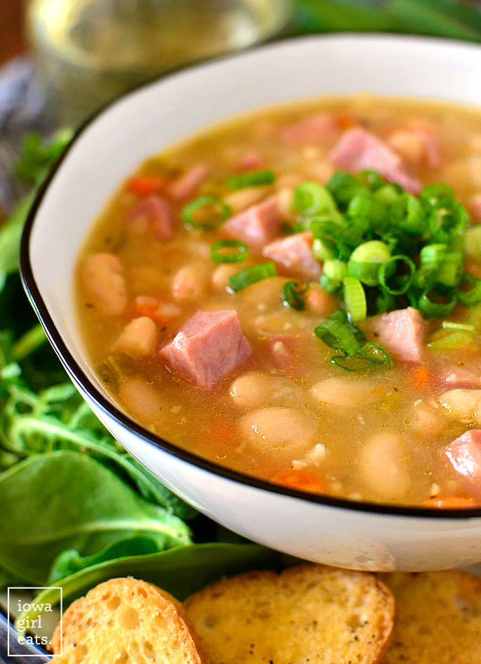 Bowl of Ham and Bean soup with green onions on top