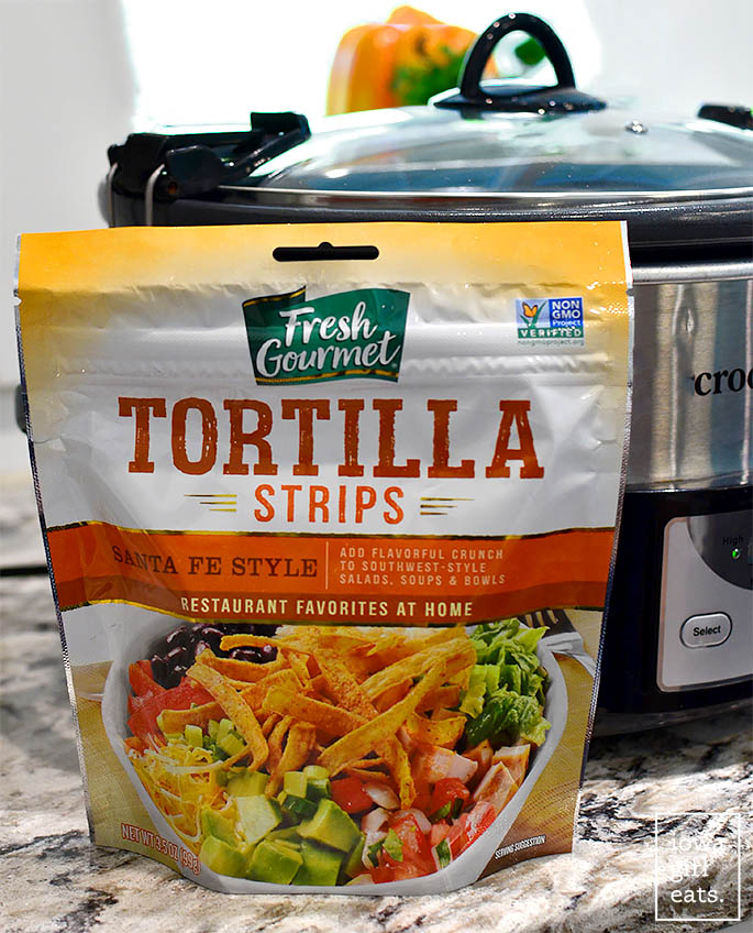 bag of tortilla strips in front of a crock pot