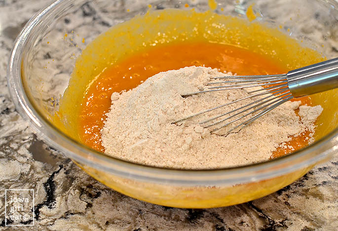 ingredients for gluten free pumpkin bread mixed together in a bowl