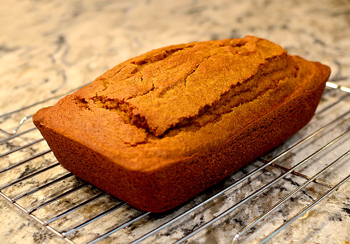 loaf of gluten free pumpkin bread cooling on the counter