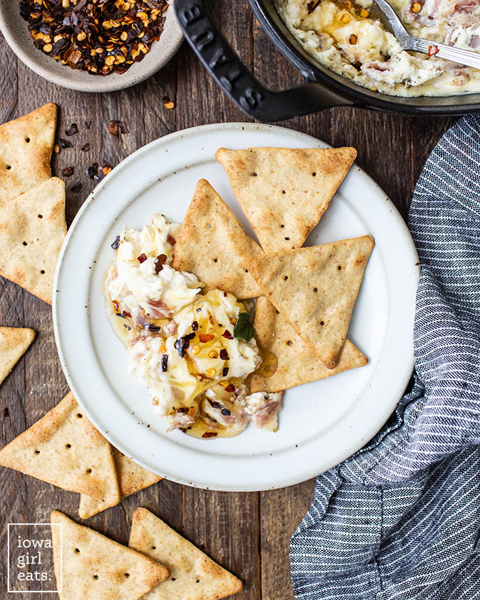 crackers on a plate with Roasted Garlic and Prosciutto Cream Cheese Dip