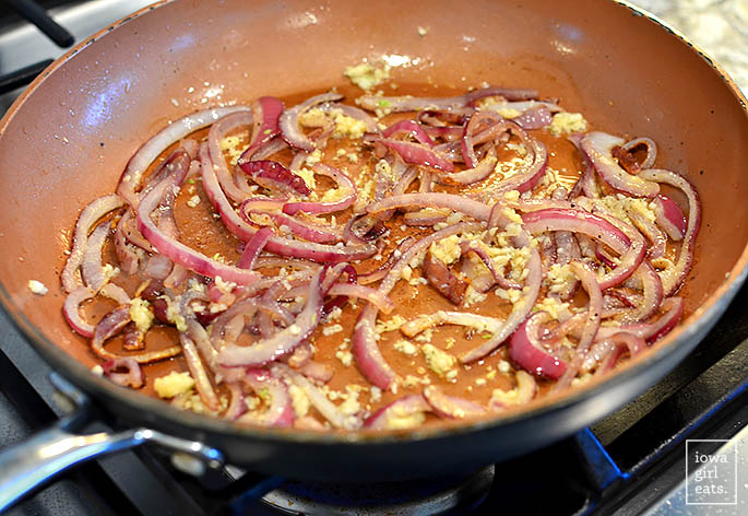 onions and garlic sauteing in a skillet