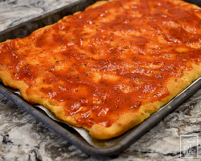 gluten free pizza crust with sauce on top