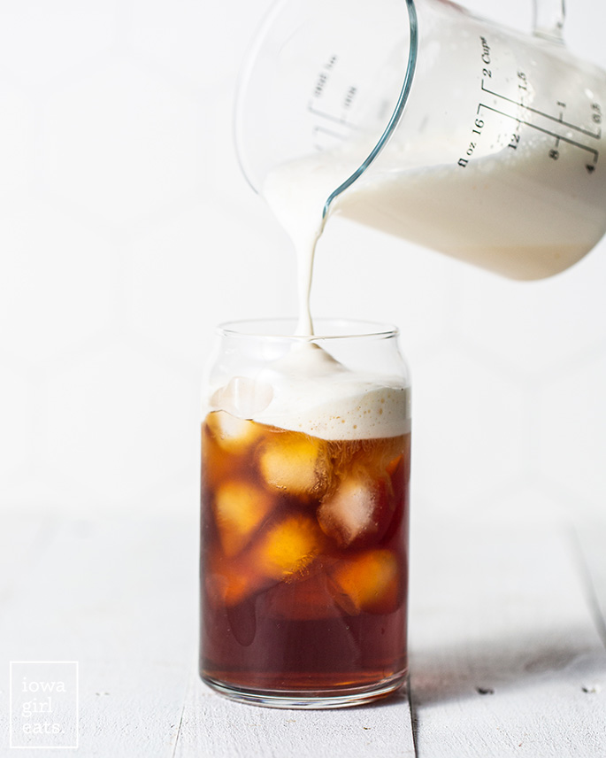 Glass of iced coffee with cold foam on top