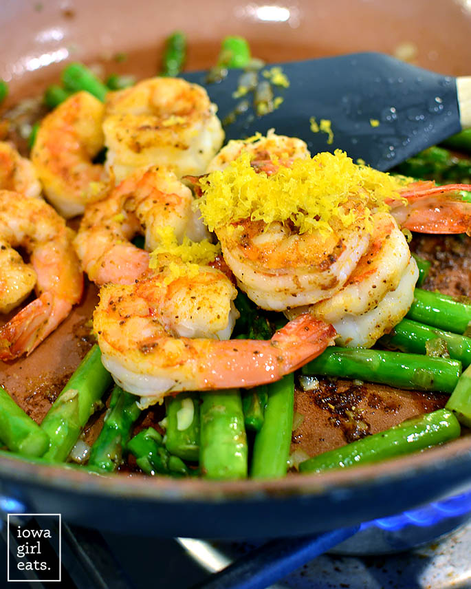 shrimp and asparagus sauting in a skillet