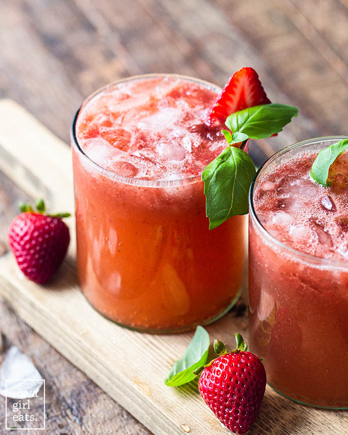 a strawberry basil ، ،tail garnished with basil and strawberries