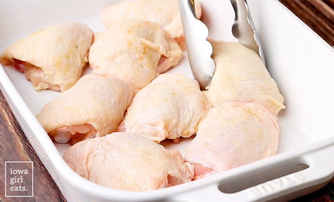 ، in skin on chicken thighs in a roasting ban