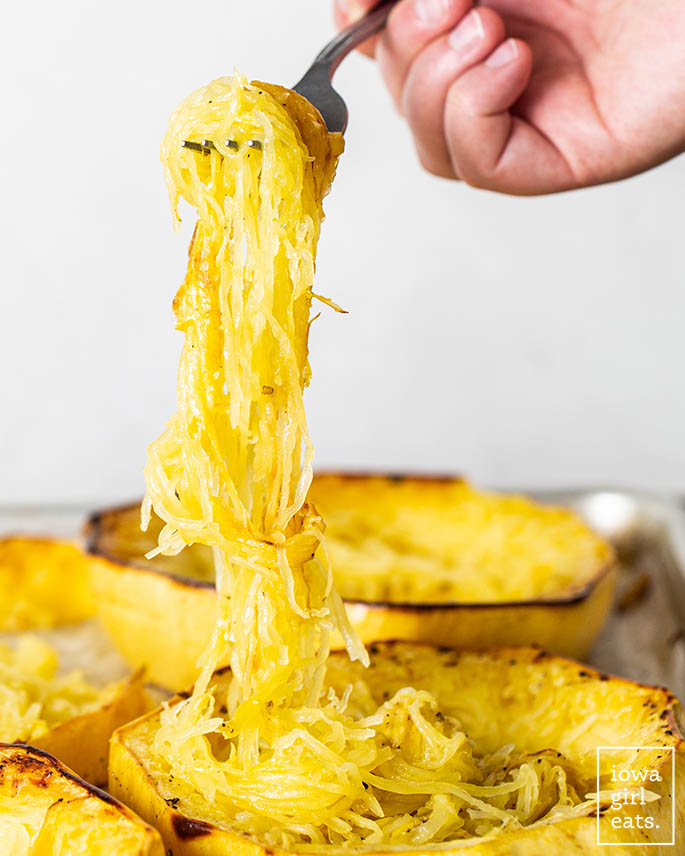 fork pulling up long strands of spaghetti squash
