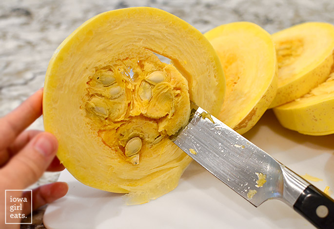 knife removing the seeds from spaghetti squash