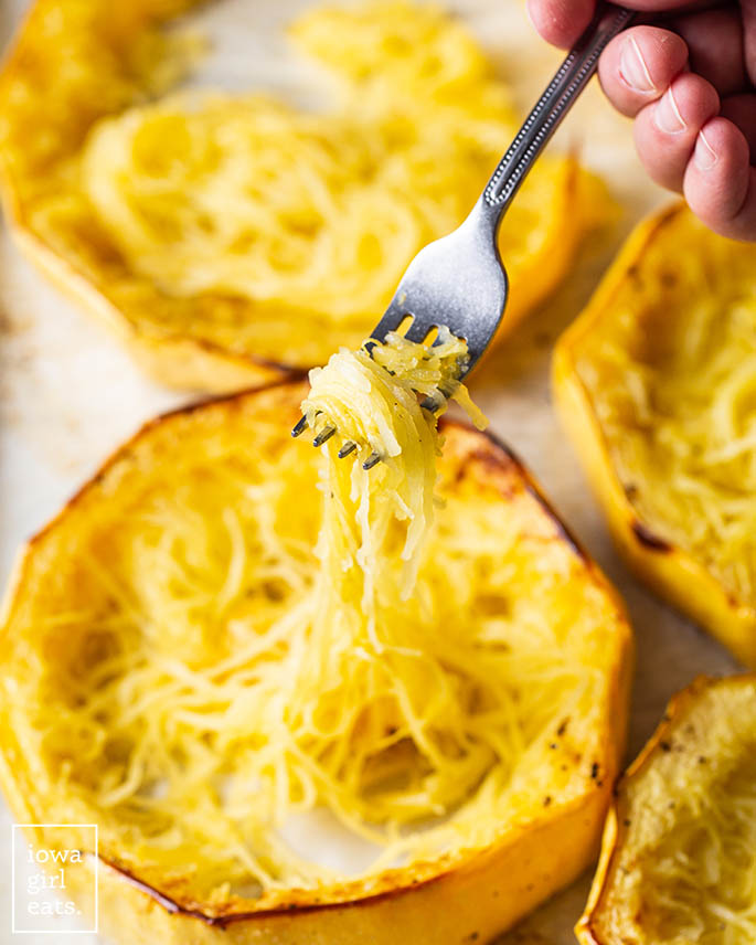 fork separating baked spaghetti squash into rings