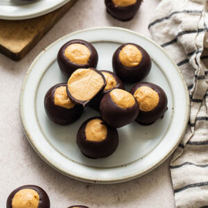 a plate of chocolate covered peanut butter balls