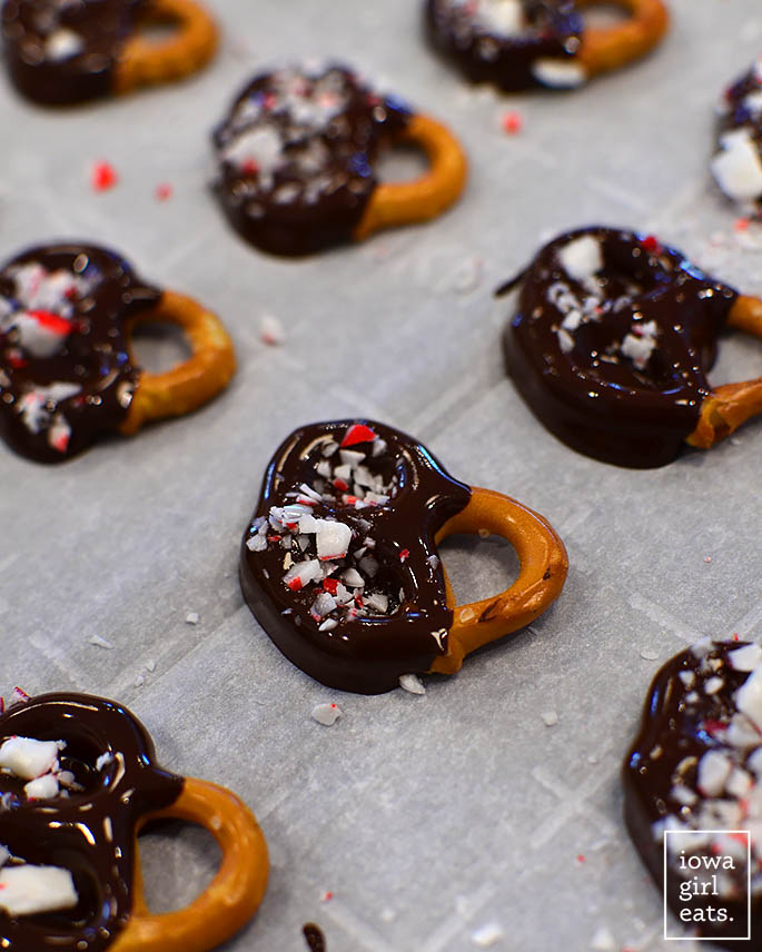 crushed candy canes sprinkled onto chocolate dipped pretzels