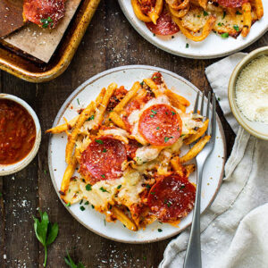 pizza fries on a plate with a fork