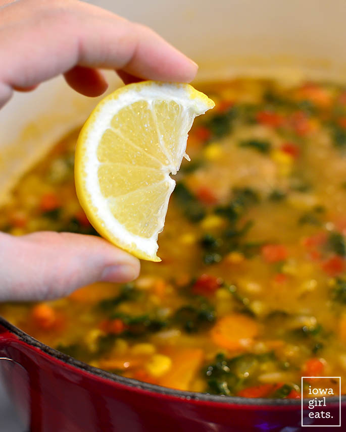 lemon juice being squeezed inside vegetable soup