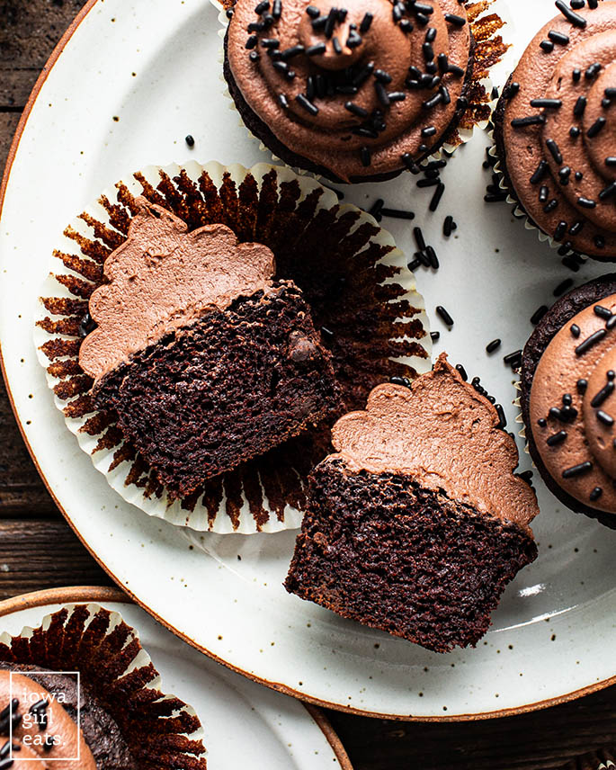 gluten free chocolate cupcakes with chocolate chips and frosting sliced in half