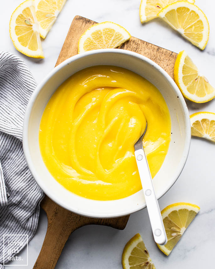 lemon curd dessert in a bowl with a s،