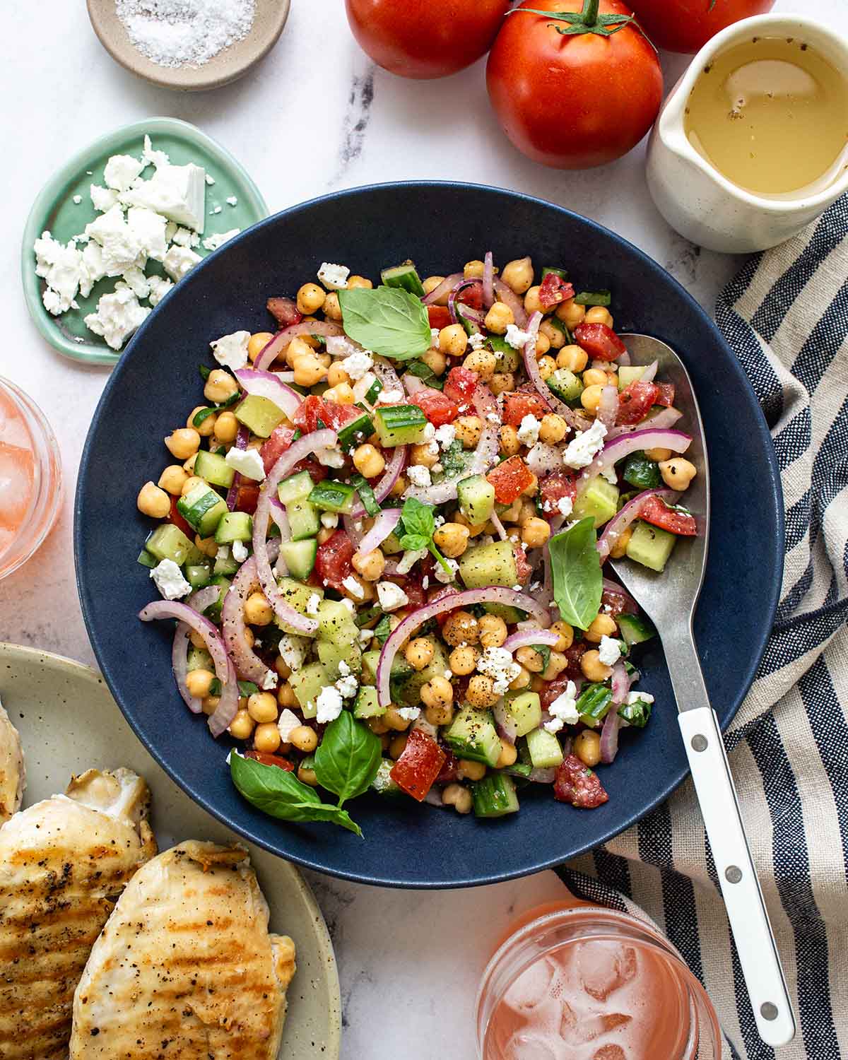 bowl of chickpea salad with a serving spoon