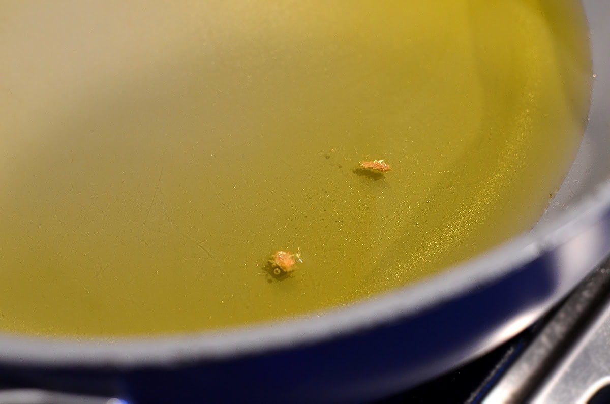 breadcrumbs sizzling in a pan of oil