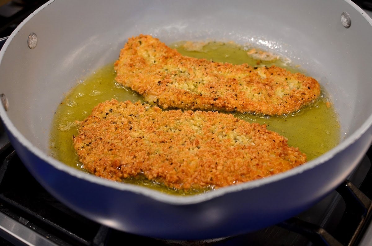 chicken cutlet frying in oil