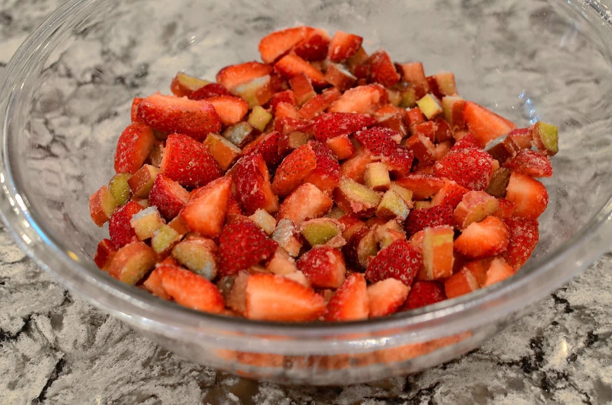 bowl of strawberries rhubarb and sugar