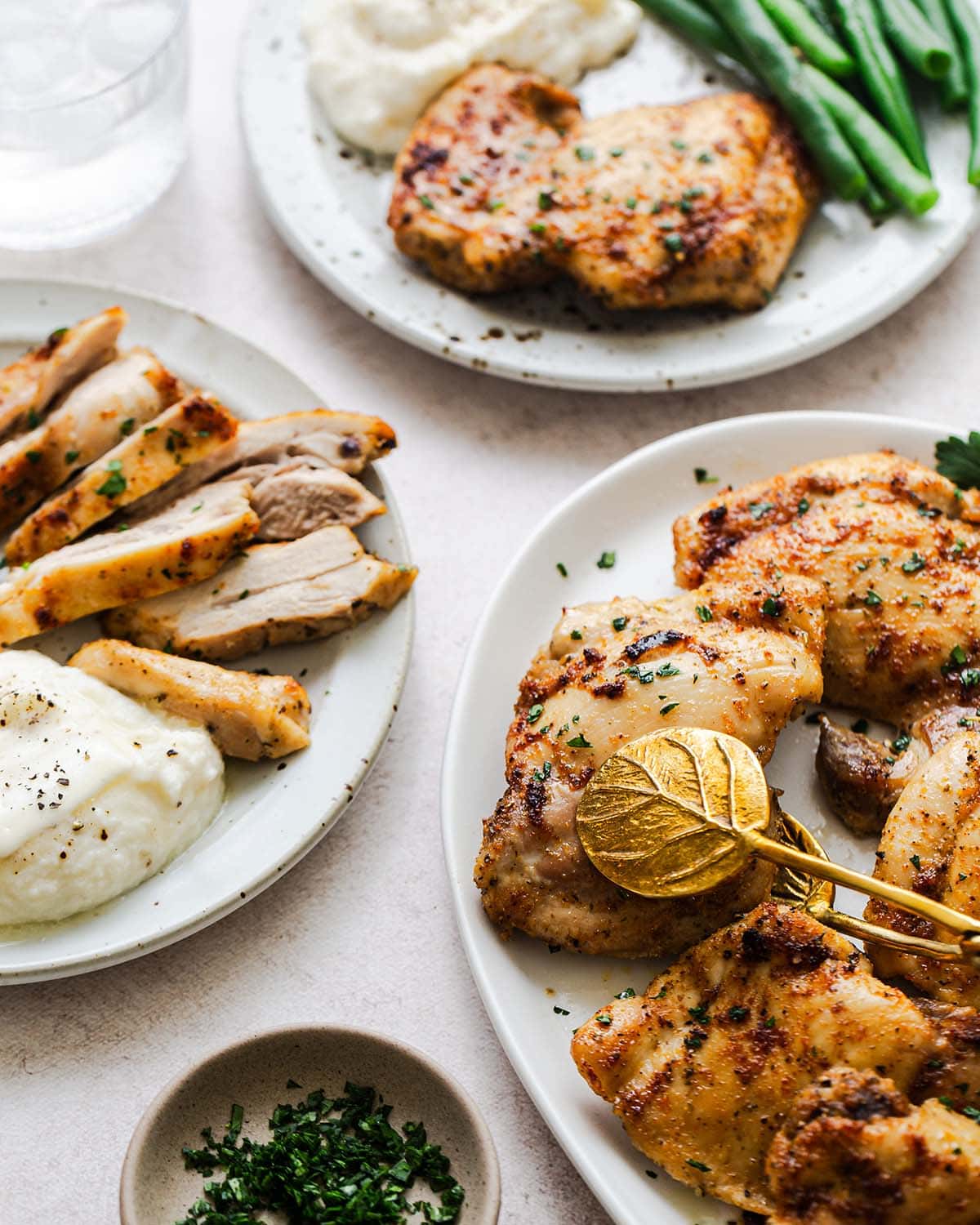 baked boneless chicken thigh slices on plates