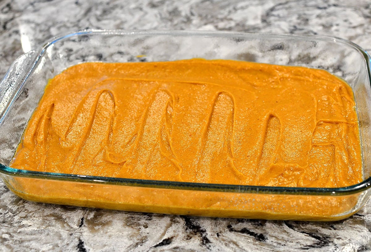 gluten free pumpkin bar batter spread in a baking pan