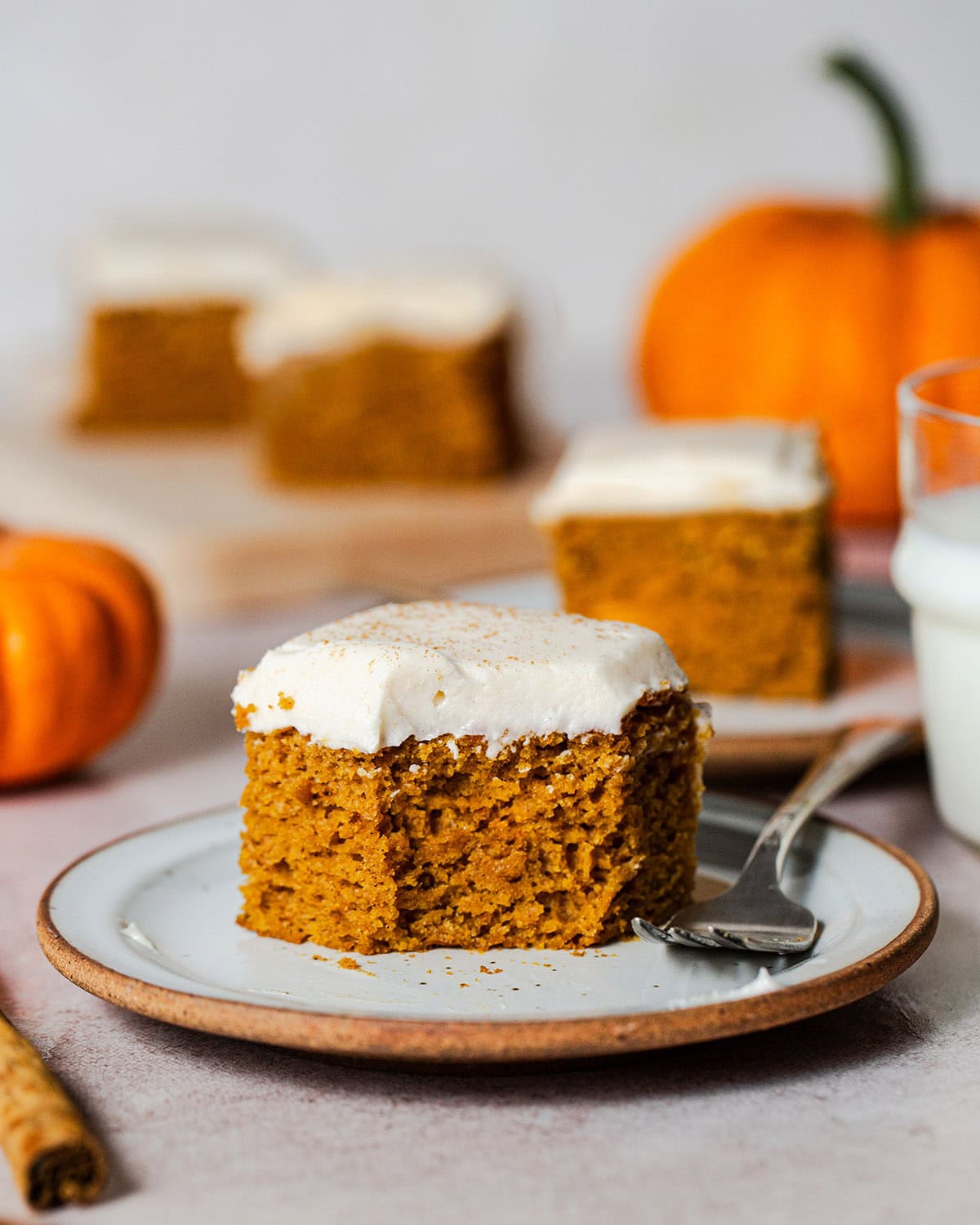gluten free pumpkin cake bar on a plate with a bite taken out